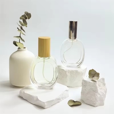 Bouteille de parfum en verre en forme d' oblate Bouteille ronde transparente Bouteille à pulvérisation portable