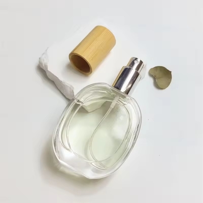 Bouteille de parfum en verre en forme d' oblate Bouteille ronde transparente Bouteille à pulvérisation portable